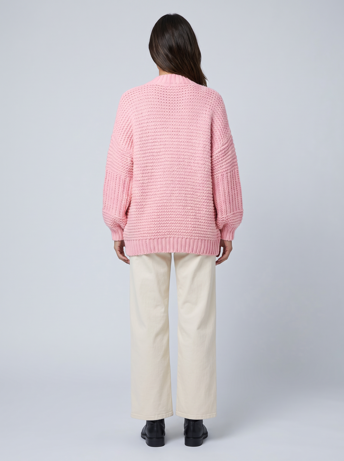 Women's pink chunky knit cardigan with buttons, long sleeves and patch pockets