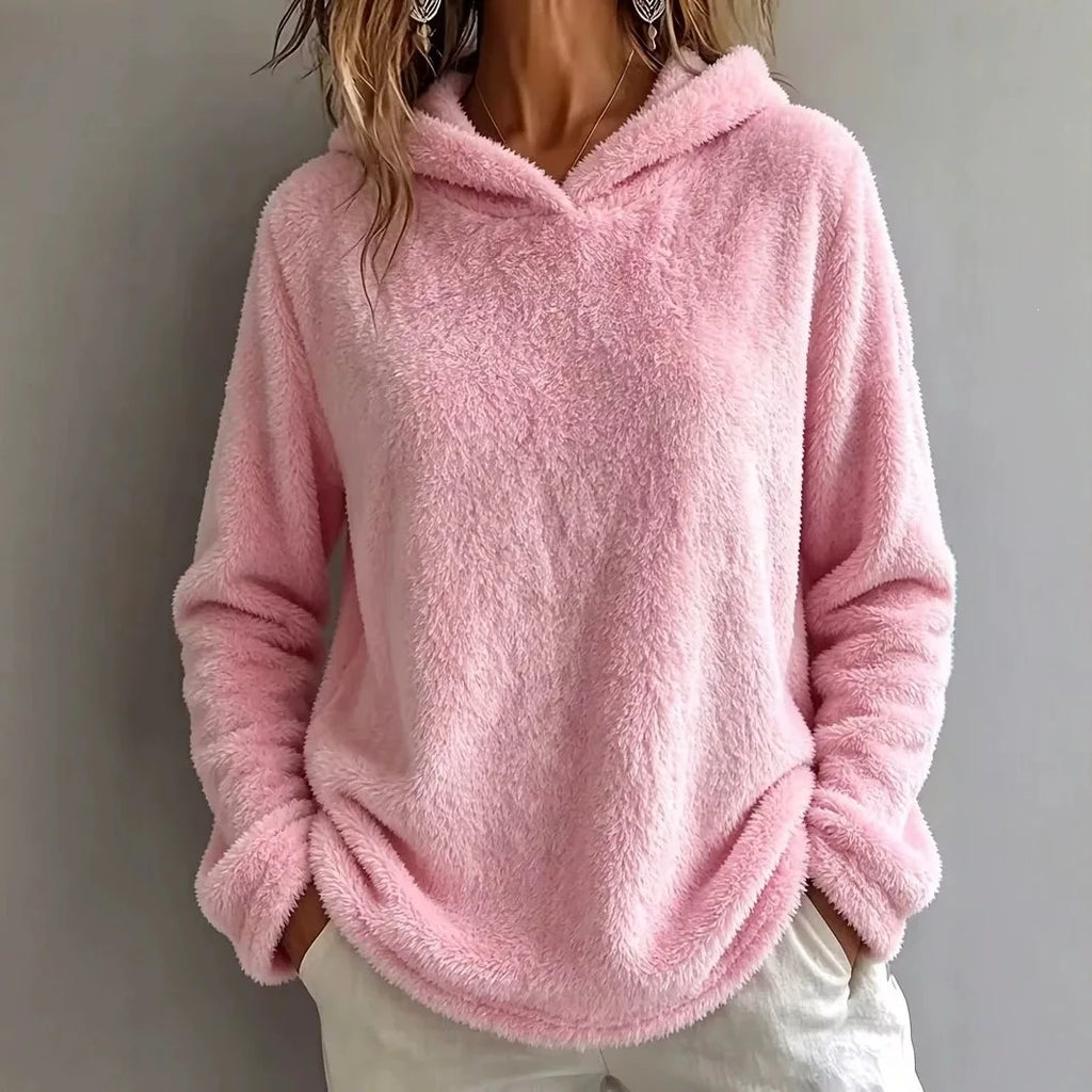 Woman wearing pink fuzzy fleece hooded sweatshirt
