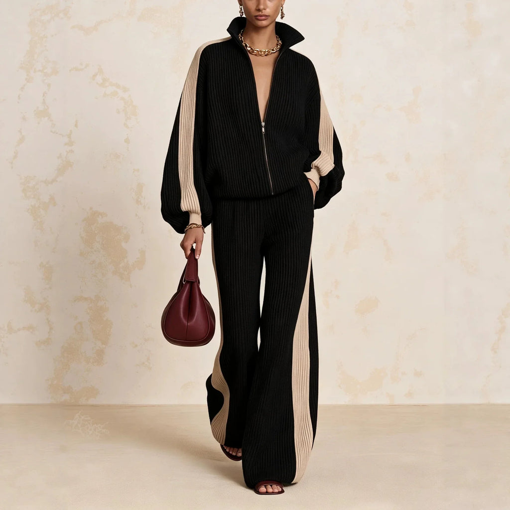Woman wearing black color block ribbed knit zip up top and wide leg pants matching set
