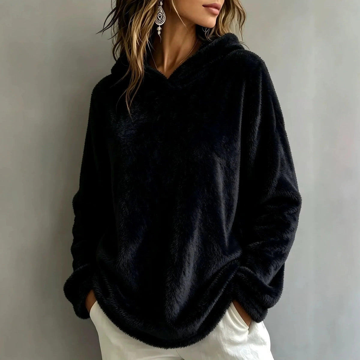 Woman wearing black fuzzy fleece hooded sweatshirt