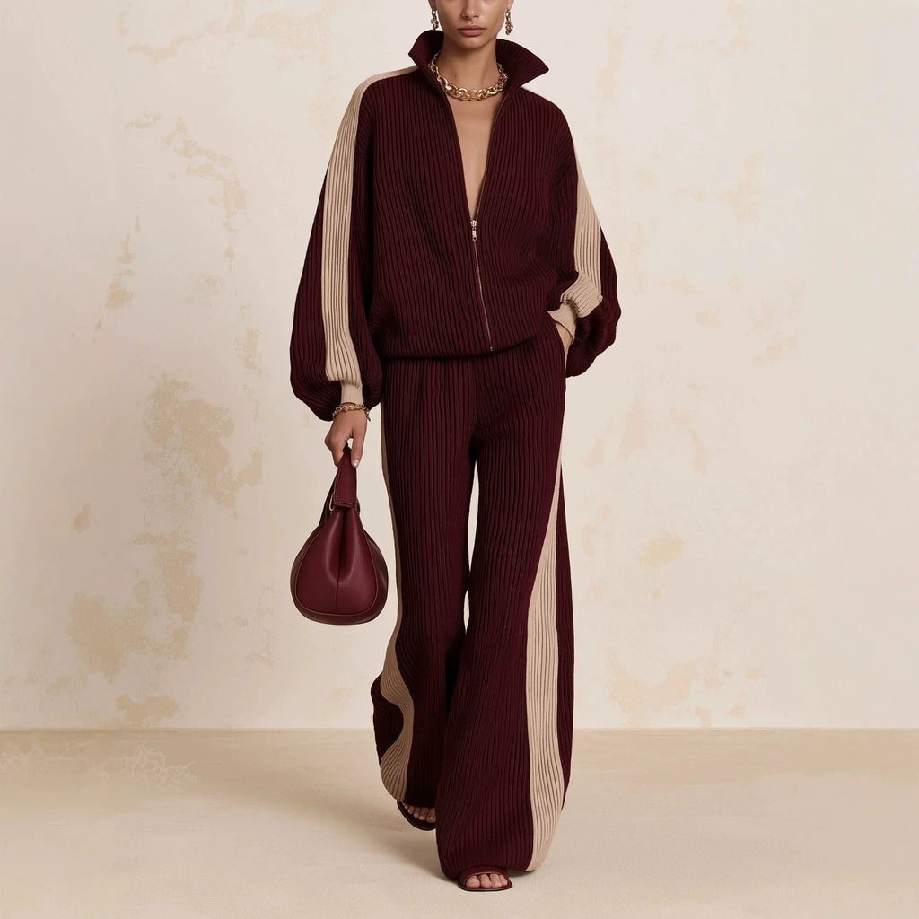 Woman wearing burgundy color block ribbed knit zip up top and wide leg pants matching set